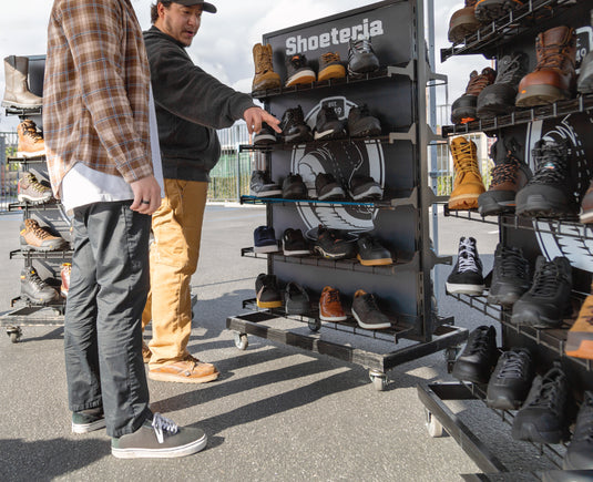Shoeteria employee helping out customer find footwear