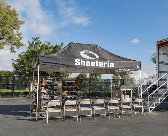 Shoemobile set up with footwear display and seven chairs 